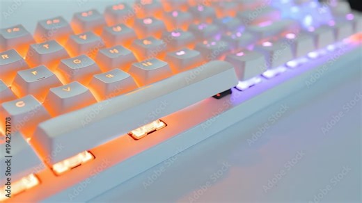 An ergonomic gaming keyboard with vibrant backlighting on a modern desk setup