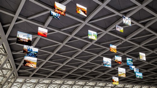 Multiple screens in China float above in a structured ceiling design