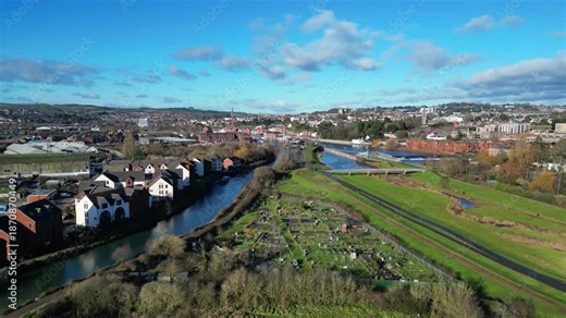Exeter, South Devon, England: DRONE VIEWS: Exeter Ship Canal (left); Trews Weir on the River Exe (right); Allotments; Apartments; Exeter Cathedral. The city of Exeter pre-dates Roman times.