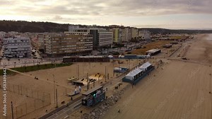 Skatepark and Surf competition tents on Sandy beach of Costa da Caparica, Aerial Pullback