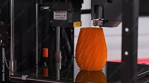 3D printer in action. Modern three dimensional printer printing a prototype
