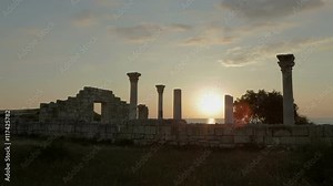 Ancient Greek basilica and marble columns in Chersonesus Taurica on the sunset background.