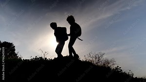 Extending a helping hand, a sibling aids their brother in a time of need, embodying the bond of family and the spirit of support.