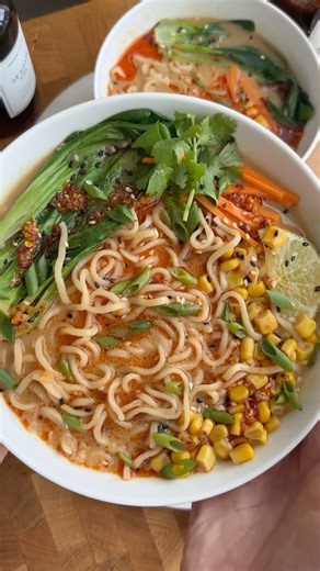PEANUT MISO RAMEN🍜 * 4-6 oz of uncooked ramen noodles * Optional baby bok choy sliced in half lengthways * 1 tsp toasted sesame oil * 1 tsp grated ginger * 1 tsp grated garlic * 1 heaping tbs peanut butter * 1 tbs miso paste * 2 cups 2 tbs veggie broth divided * 1 cup lite coconut milk * 1-2 tbs soy sauce * Optional for Garnish: chili oil corn, sesame seeds, green onions, julienned carrots 1️⃣ Bring a small pot of water to a boil that’s enough to cook your noodles in. Once boiling, add in the n
