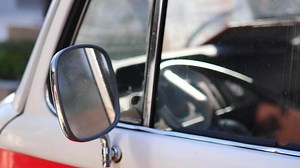 Download A detailed closeup view of a vintage vehicles side mirror and its interior features for free