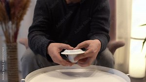 Fortune teller is telling fortunes. He looks at the coffee fortune of the person standing in front of him. The fortune teller interprets and explains.