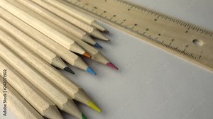 pencils and a hand coloring an adult coloring book. dolly shot, sliding camera move.