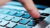 Finger of the computer user, he presses the delete button on the...