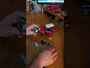 How do you replace the battery of the Mini Cooper remote control?