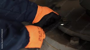 screwing nut, Twist mechanic, Nut tightening. Using wrench laborer industrial plant either tightens loosens nut on bolt.