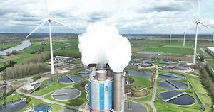 Aerial drone view on a smoke stack emmision of smog and smoke. Industrial pollution, factory chimney vapor. Smoking fumes of waste incineration installation. Close up aerial drone view.