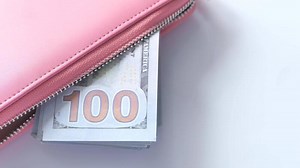 Download A pink wallet with money inside for free