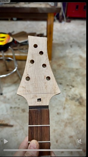 Working on the headstock. Off camera I got the 2 front veneers and the backstrap installed. Had to get out the old hot pipe bender for the backstrap veneer, it was too thick to press fit. I was going for a dark strip look under the maple front veneer and I used what rosewood was left from the arm bevel to sandwich between the mahogany (hog) and the maple. After doing so, it’s so thin I don’t know if you’d be able to tell it apart from a glue line. I glued it in anyway because I calculated the th