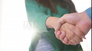 Man is handing girl handshake. deal hand shake concept. lifestyle business partners handshake. contract. a man hands a girl a contract with a business.