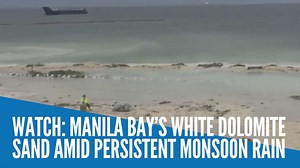 As rain spawned by Typhoon Fabian’s enhancement of the southwest monsoon continues, the white dolomite sand of Manila Bay “slightly” drifted from the shore while garbage also piled up on the beach. | INQUIRER.net