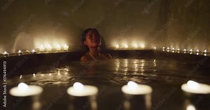 Woman relaxing in spa jacuzzi going out leaving the hot tub spa treatment.