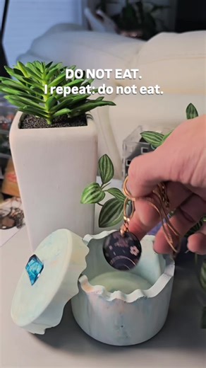 A handmade ceramic resin puzzle jar that looks like a macaron and opens like it has trust issues. Pastel swirls, a gemstone handle, and zero intention of being edible. Custom color palettes available. #handmadedecor #pasteldecor #puzzlejar #functionalart #uniquedesign