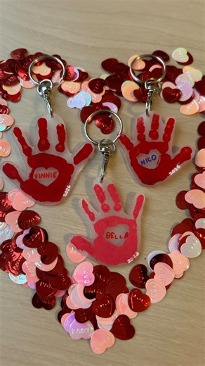 Becca | CozyCraftMama on Instagram: "DIY handprint Valentine keychains for parents, grandparents, and kids 💖 A little Valentine’s keepsake you’ll treasure forever 🥹 Made with heat shrink paper, these take just a few simple steps: 1. Paint and decorate your handprints ✋🎨 2. Cut out the handprint and punch a hole for the keychain ✂️🔑 3. Bake in the oven and watch them shrink (kids love this part!) 🔥 4. Attach your keychain ✨ Comment KEYCHAIN and I can send over the detailed directions, tips a