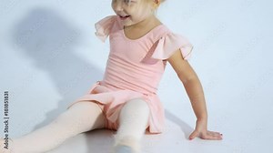 A small ballerina dances with enthusiasm. The girl is engaged in ballet