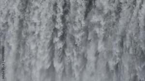 Immense waterfall captured in stunning detail. Tons of water, torrential flow cascading down, creating a mesmerizing and intricate texture. Display of nature's power. Slow motion 4k stock footage. Stock Video