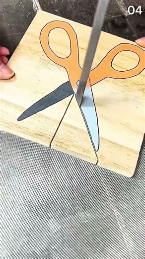 Saw blade splits painted scissors—illusion snaps wood in half with clever cut and crafted trick