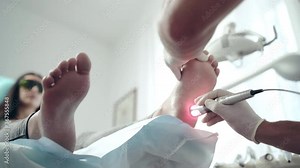 Flat-foot intensive therapy in medical centre, specialist in gloves holding treatment procedures with patient's feet in medical room. Specialized lazer equipment for healing diseases, orthopedist and Stock Video