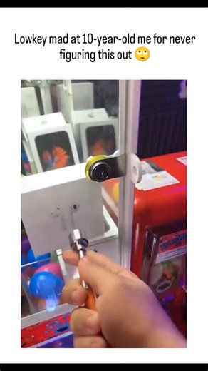 Hacker001😝 on Instagram: "The post shares a 20-second video of a person using a telescoping magnet tool to manipulate an arcade claw machine, extracting bundled cash prizes without paying the $2 fee, humorously lamenting not discovering it as a child. With 46,000+ likes and 10 million views in under 24 hours, it taps into viral nostalgia for arcade exploits, though replies debate its authenticity, citing empty prize setups and the need for rare earth magnets unavailable to kids. Known since 201