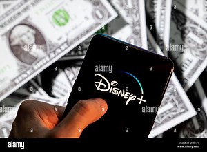 China. 23rd Apr, 2021. In this photo illustration the online video streaming subscription service platform owned and operated by Disney, Disney  (plus), logo seen on an Android mobile device screen with the currency of the United States dollar icon, $ icon symbol in the background. (Photo by Budrul Chukrut/SOPA Images/Sipa USA) Credit: Sipa USA/Alamy Live News Stock Photo - Alamy