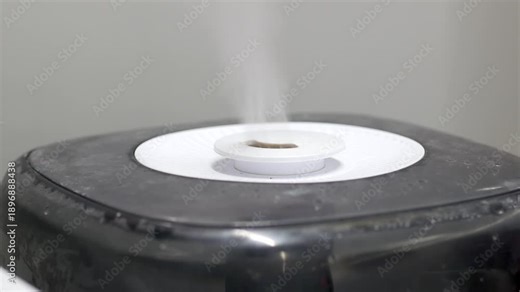 Steam rises from a humidifier in a room setting