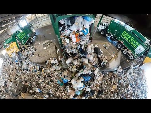 Garbage trucks dumping at transfer station.