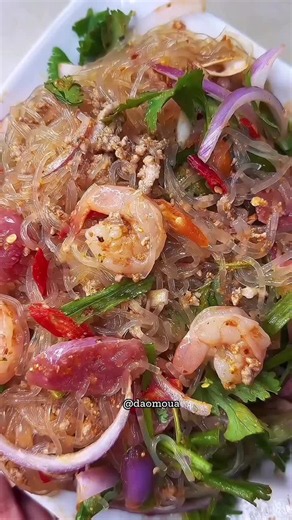 Spicy Noodle Salad Recipe (Laab Woon Sen) 1. Soak 1 small bundle of bean thread noodles in room temperature water for 10–15 minutes. Drain, cut into shorter pieces, and cook until soft and translucent. 2. Cook 3 tbsp ground pork with 1/4 cup water until fully done. 3. In a bowl, combine cooked shrimp, ground pork, glass noodles, and fermented pork sausage. 4. Toss in thinly sliced red onion or shallots, chopped green onions, cilantro, basil, mint leaves, and red chili peppers. Dressing: - 1 tbsp
