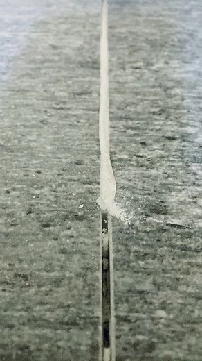 Expanding Foam in Concrete Crack Close-Up