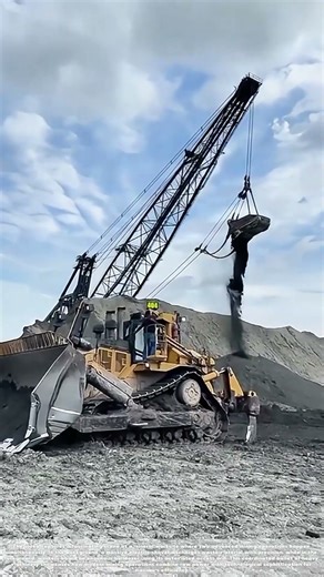 Mining Marvels: Giant Shovel Dumps While Workers Ride Robotic Arms!