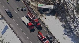 Traffic snarled on I-495 in Hudson after truck crashes off highway and into wooded area