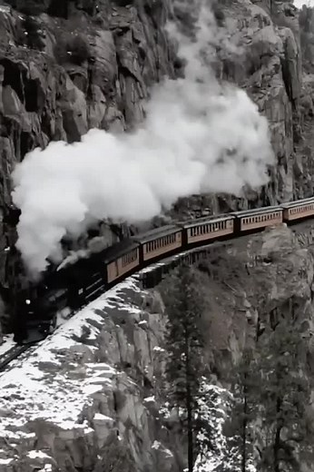 Vintage Steam Train Journey Through Snowy Mountains