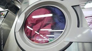 Washing machines in laundry room with rotating drums