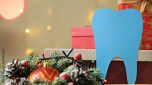 Christmas dentistry - tooth on the background of flashing garlands and gift boxes. Stock Video