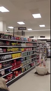 Girl practices tumbling skills inside Target store
