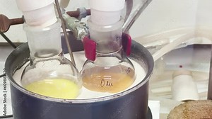 Colourful reactions under heating condition in sand bath. 4K video experiments in a chemistry lab. Biochemical medicine synthesis in the laboratory. Stock Video