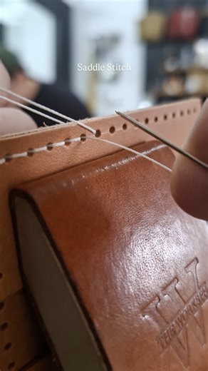 The traditional way of hand stitching leather goods. The saddle stitch uses one thread and 2 needles weaving the needles through each set of holes from both sides creating an incredibly strong stitch on handcrafted leather goods. | The Works PH