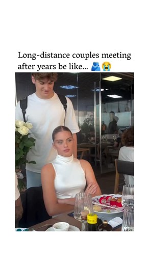 spectr.iq on Instagram: "The post shares a 25-second video depicting a staged long-distance couple reunion at a restaurant, where a friend hugs and kisses the waiting woman from behind, prompting her initial joy before shock upon turning, followed by the real partner's emotional arrival with flowers. Replies overwhelmingly inject humour, with users speculating on infidelity based on her unguarded affection towards the impostor, amplifying the clip's comedic twist amid its heartfelt core. With 1.