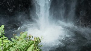 Water from powerful Akaka Falls in Hawaii crashes into pool. Slow motion.