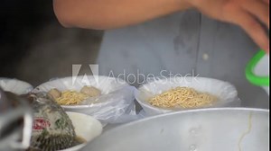 Street food vendor preparing customer order and packing in polypropylene bag. Concept for unhealthy food cause containers contaminated with chemicals.Toxins can accumulate in the body.