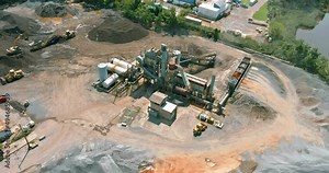 Production industrial asphalt factory surrounded by piles of gravel the aerial viewed