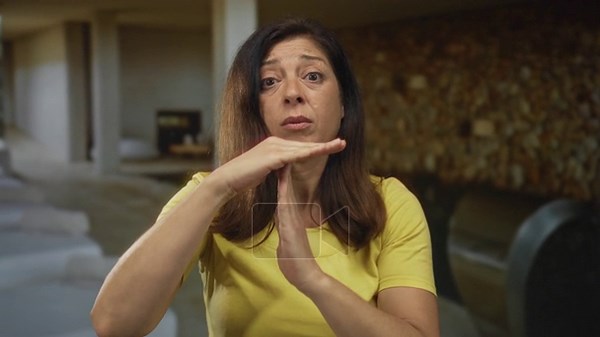 Woman makes timeout sign with hands at indoor spa pool lounge surrounded by tiled walls; calm pause Stock Video Footage - Alamy