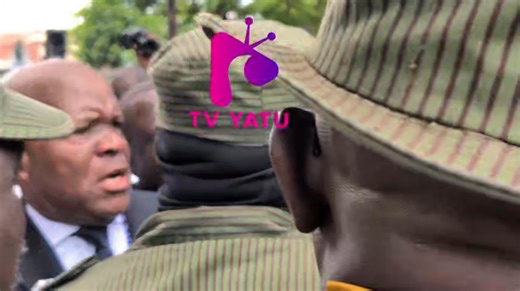 WATCH: I am a lawyer, cries Dr. Fred M'membe after police officers stop him from crossing to DEC with Archbishop Alick Banda, for questioning over a Toyota Hilux allegedly illegally obtained from ZRA by the Archbishop. ©️ TV Yatu January 5,2025. | TV Yatu