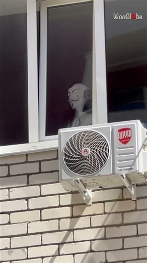 Masked Figure Stares Through A High-Rise Window - Chilling Encounter