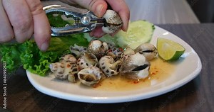 Cooking mussels in a pot of boiling water. On a black background. shell opener Seafood