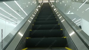 Using Escalator. Point of view or POV Video footage. Close up shot of empty moving staircase running up and down. Modern escalator stairs move indoors going up and down. Escalator with glass sides.