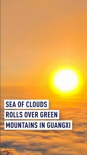 Sea of clouds rolls over green mountains in Guangxi